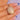 Foliate engraved face of locket held close