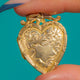 Opposite face of the heart locket showing its unengraved shield cartouche