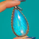 Blue Morpho butterfly wing pendant in Silver, front on blue background